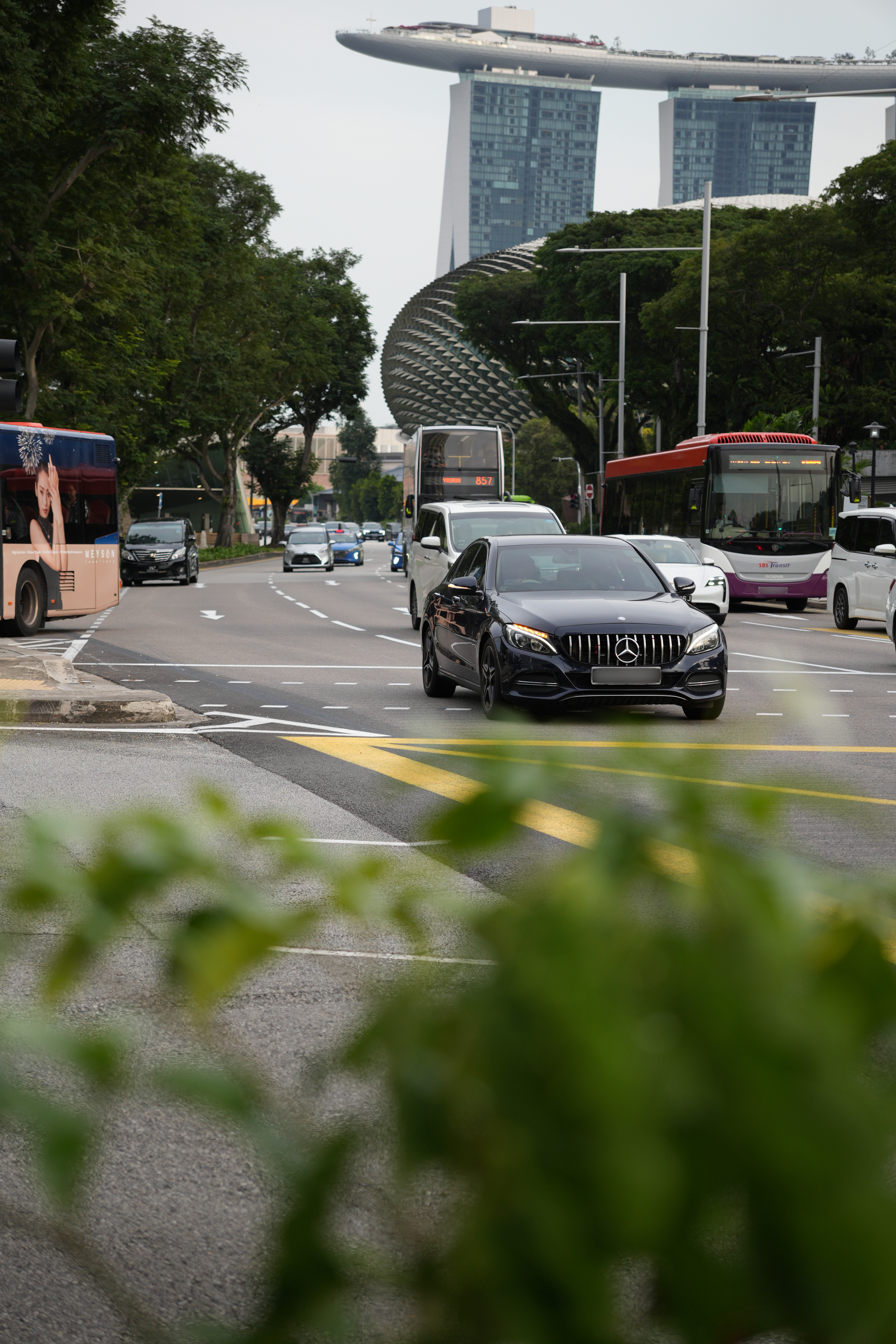 Black Mercedes Benz on the street with Marina Bay Sands in the background