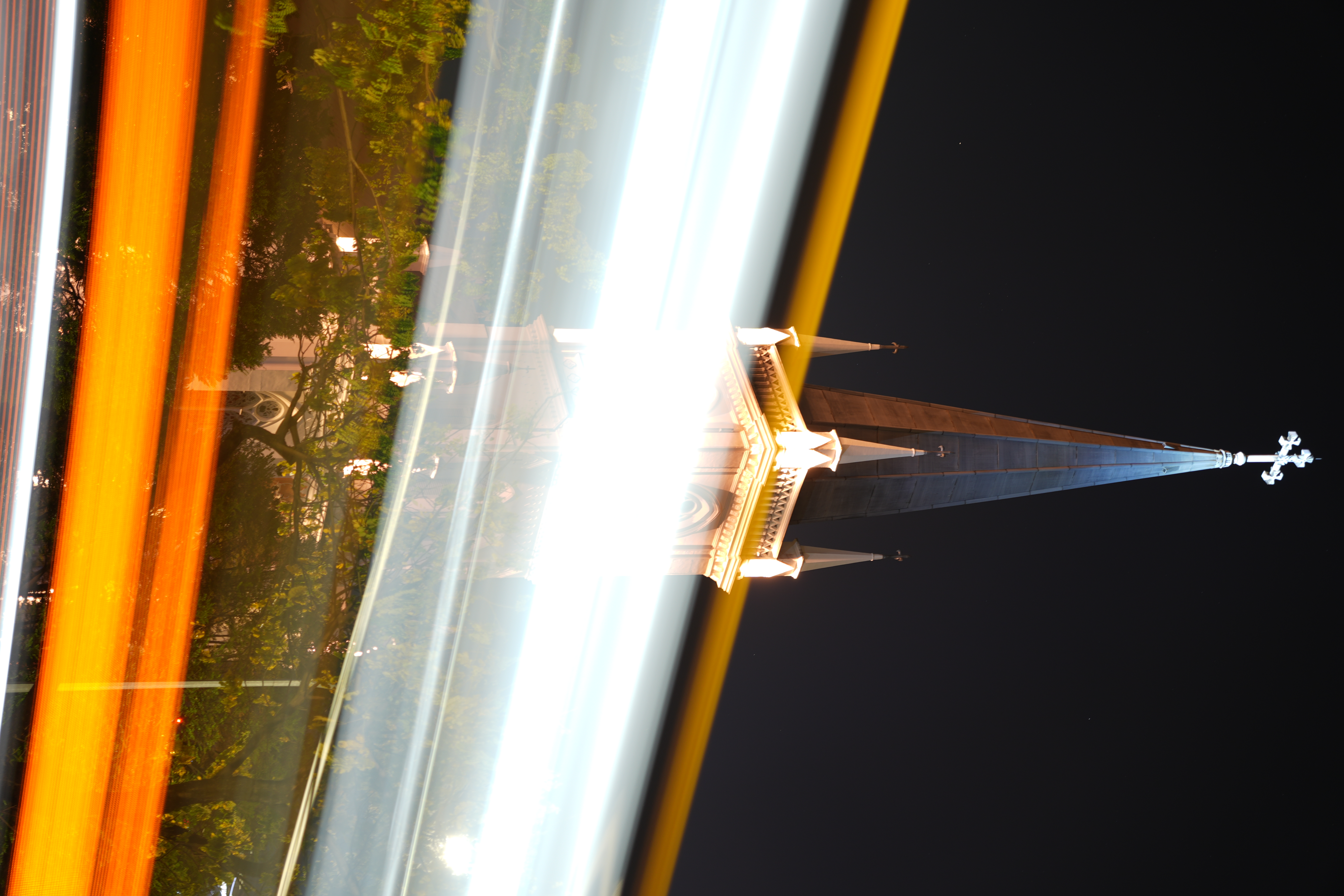 Long exposure image of bus passing by a christian church